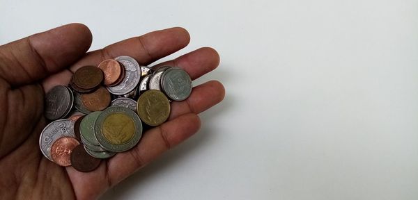 Cropped image of hand holding coins