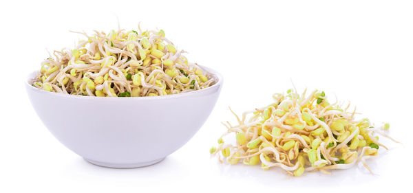 Close-up of fresh vegetables in bowl against white background