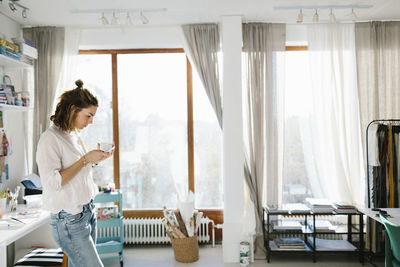 Young woman in home workshop