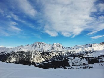 Scenic view of snowcapped mountains against sky