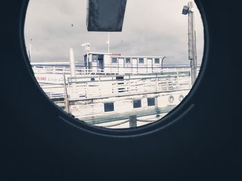 Buildings against sky seen through glass window