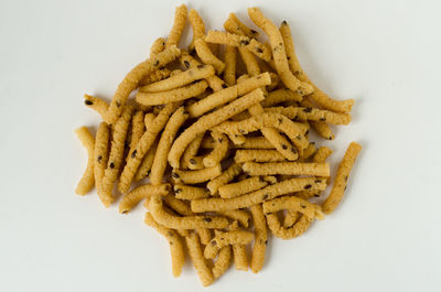 Close-up of pasta on plate against white background