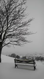 Bench against sky during winter