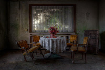 Empty chairs by table at home