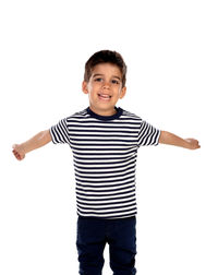 Portrait of smiling boy standing against white background