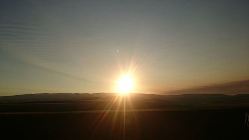 Scenic view of silhouette landscape against sky during sunset