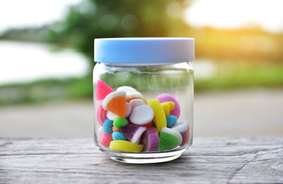 Close-up of colorful candies in jar on table