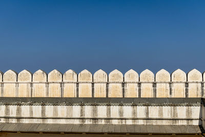 Low angle view of built structure against clear blue sky