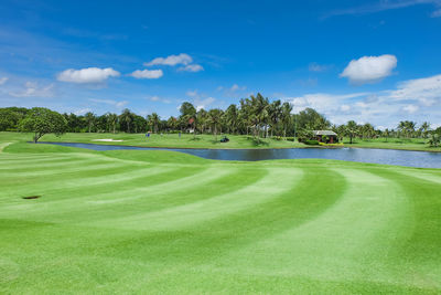 Scenic view of golf course against sky