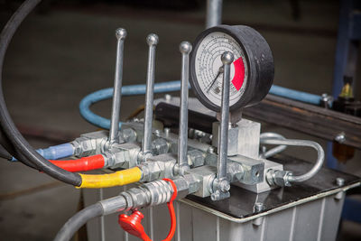 Close-up of the hydraulic control panel with levers and pressure gauge