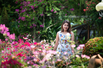 Portrait of smiling woman with pink flowers