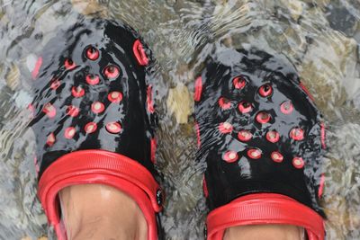 Low section of person wearing red shoes