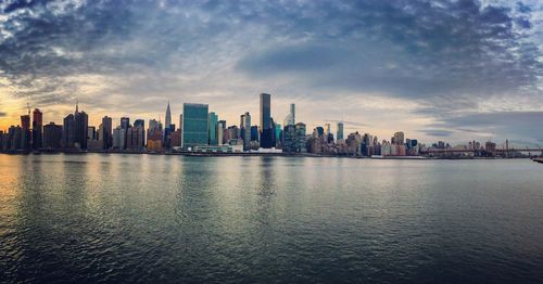City skyline against cloudy sky