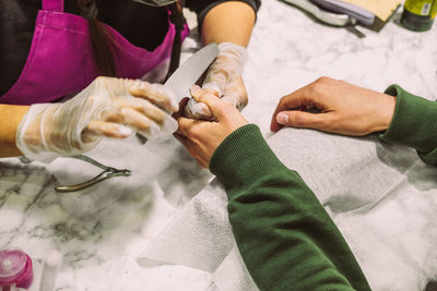 Women's hands in the manicure process close-up