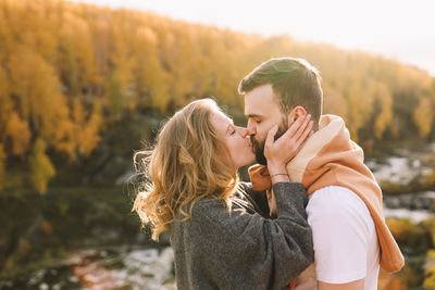 Happy people in love are travel hike in nature in the autumn forest. romantic trip to countryside