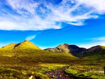 Scenic view of mountains against blue sky