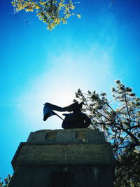 Low angle view of statue against clear blue sky