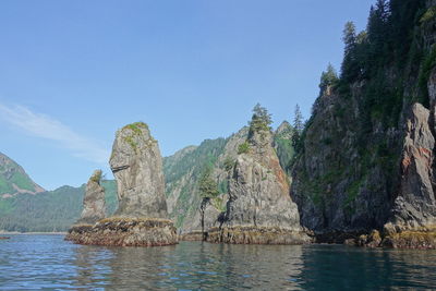 Panoramic view of rocks on shore against sky