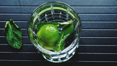 High angle view of lemon and herb in drink on table