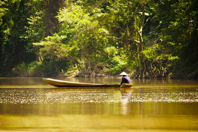 Man sailing boat in lake