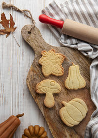 Autumn baking. cookies in the form of pumpkin and leaves on the table. cozy autumn concept.