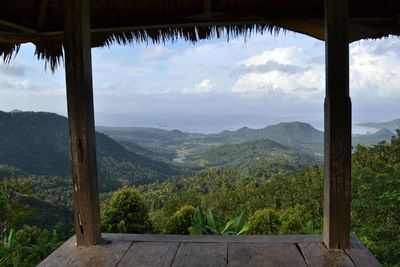 Scenic view of mountains against sky seen through window