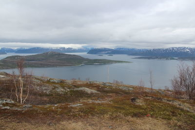 Scenic view of lake against cloudy sky