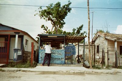 Rear view of woman on street against buildings