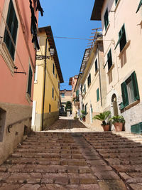 Street amidst buildings in town against sky