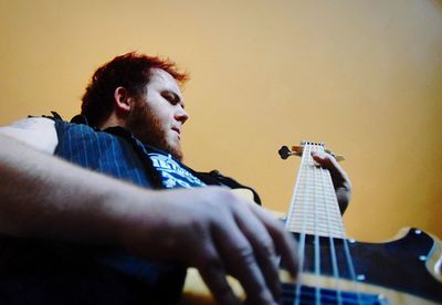 Low angle view of man playing guitar