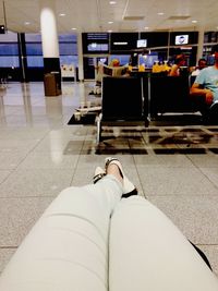 Low section of people sitting on floor