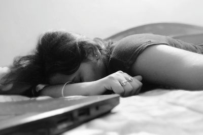 Woman relaxing on bed at home