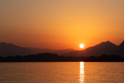 Scenic view of lake against sky during sunset