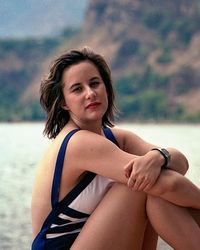 Portrait of beautiful young woman sitting at beach