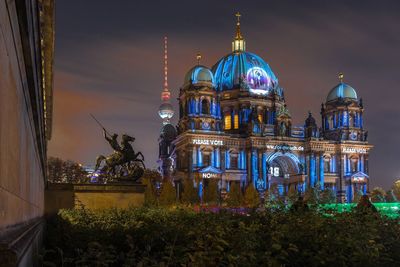 Illuminated building against sky at night