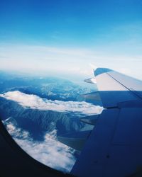 Airplane flying over sea against sky