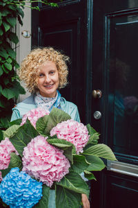 Portrait of young woman with bouquet