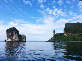 Rock formations in sea against sky