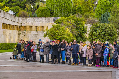 Group of people against plants