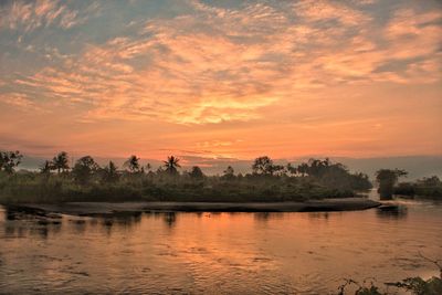 Scenic view of lake against orange sky