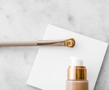 Close-up of beauty products against white background