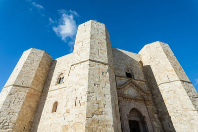 Low angle view of historical building against blue sky