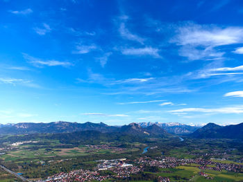 Aerial view of townscape against blue sky