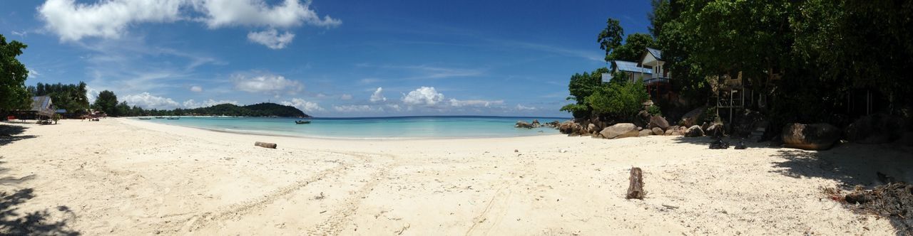 beach, sand, sea, shore, water, tranquility, tranquil scene, sky, scenics, beauty in nature, tree, nature, coastline, palm tree, horizon over water, incidental people, blue, panoramic, idyllic, sunlight