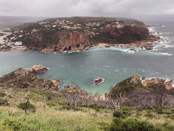 High angle view of sea and rocks against sky