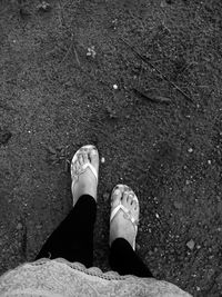 Low section of woman standing on ground