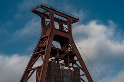 Low angle view of communications tower against sky