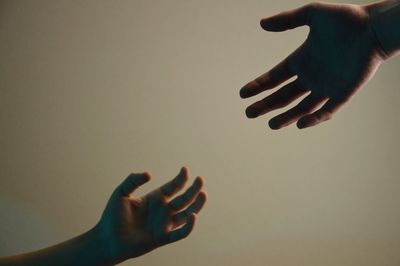 Cropped hand of people against white background