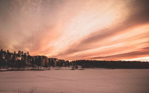 Scenic view of snow field against sky during sunset