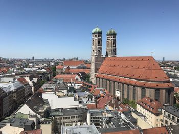 Buildings in city against clear sky